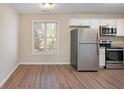 Eat-in kitchen with stainless steel appliances and hardwood floors at 30 Sampson Ct, Covington, GA 30016