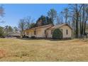 Ranch-style home with a spacious yard, mature trees, and a detached garage at 3439 Elm Creek Nw Dr, Marietta, GA 30064