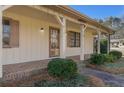 Inviting covered front porch featuring brick accents and manicured bushes at 3439 Elm Creek Nw Dr, Marietta, GA 30064