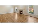 Bright living room featuring hardwood floors and a cozy fireplace at 52 Ivy Chase Ne, Atlanta, GA 30342