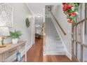 Inviting entryway with hardwood floors, staircase, and neutral paint colors at 7524 Portbury Park Ln, Suwanee, GA 30024