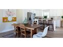 Open concept dining room showcases kitchen, natural light, and hardwood floors at 1370 Valley View Rd, Dunwoody, GA 30338