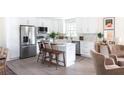 Bright, open kitchen featuring white cabinets, stainless steel appliances, and a central island at 1370 Valley View Rd, Dunwoody, GA 30338