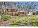 Beautiful brick house featuring a well-maintained lawn with mature trees and a welcoming front porch at 2447 Caladium Ne Dr, Atlanta, GA 30345