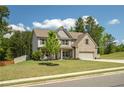 Well-maintained two-story home with brick accents, a large front yard, and a tree-lined street at 2106 Sycamore Ln, Loganville, GA 30052