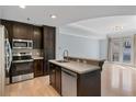 Modern kitchen featuring stainless steel appliances, dark wood cabinets, and a central island at 2255 Peachtree Ne Rd # 426, Atlanta, GA 30309