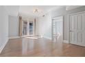 Bright living room featuring hardwood floors, neutral paint, and a balcony with double doors at 2255 Peachtree Ne Rd # 426, Atlanta, GA 30309
