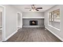 Cozy living room featuring a stone fireplace and wood-look floors at 2653 Del Ridge Dr, Douglasville, GA 30135