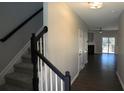 Inviting entryway with staircase, modern lighting, and access to a spacious living area at 3374 Thornbridge Dr, Powder Springs, GA 30127