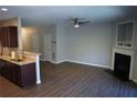 Open living area with fireplace, modern flooring, and a view into the adjacent kitchen at 3374 Thornbridge Dr, Powder Springs, GA 30127