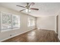 Bright living room featuring hardwood floors, large windows and ceiling fan at 2239 Pinewood Dr, Decatur, GA 30032