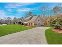 View of the house showcasing a long driveway and multi-car garage at 1293 Wynford Colony Sw, Marietta, GA 30064