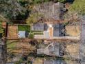 An aerial view reveals the property's layout, including a lush backyard and detached garage at 3125 Peachtree Ne Dr, Atlanta, GA 30305