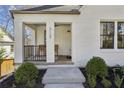 The front porch offers a cozy seating area and inviting entrance with blue painted ceiling at 3125 Peachtree Ne Dr, Atlanta, GA 30305