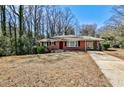 Charming red brick home featuring a well-maintained front yard and a convenient carport at 1269 Lawndale Ct, Decatur, GA 30032