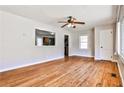 Bright living room featuring hardwood floors, a ceiling fan, and a view into the kitchen at 1269 Lawndale Ct, Decatur, GA 30032