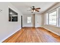 Bright living room featuring hardwood floors, a ceiling fan, and two bright windows at 1269 Lawndale Ct, Decatur, GA 30032