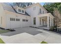 Side view of a pristine two-story home featuring an attached two-car garage at 52 25Th Nw St, Atlanta, GA 30309