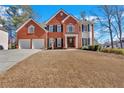 Elegant brick home with a well-maintained lawn, beautiful shrubbery and a two car garage at 577 Alexander Farms Sw Vw, Marietta, GA 30064