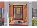 Inviting front entryway with brick columns, potted plants, decorative wreath and brick walkway at 577 Alexander Farms Sw Vw, Marietta, GA 30064