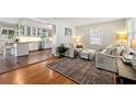 Cozy living room area with a large window, hardwood floors, and seamless flow into the kitchen at 1147 Longshore Dr, Decatur, GA 30032