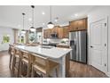 Well-designed kitchen boasts stainless steel appliances, a center island with bar seating, pendant lighting, and generous cabinet space at 181 Delilah St, Mcdonough, GA 30252