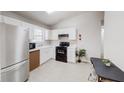 Well-lit kitchen with stainless steel appliances and white cabinets at 1284 To Lani Path, Stone Mountain, GA 30083