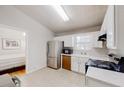 Bright kitchen with stainless steel refrigerator and adjacent bedroom entrance at 1284 To Lani Path, Stone Mountain, GA 30083