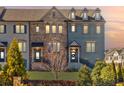 Elegant townhome exterior featuring mixed materials, a cozy entrance, and professionally maintained landscaping at 1923 Skyfall Ne Cir, Atlanta, GA 30319