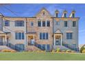 Attractive townhome exterior showcasing brick accents, complemented by lush green lawn and elegant shutters at 1923 Skyfall Ne Cir, Atlanta, GA 30319