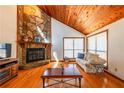 Bright living room with a stone fireplace and wood ceilings, providing a warm ambiance at 2191 Spear Point Dr, Marietta, GA 30062