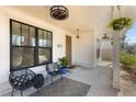 Inviting front porch with stylish seating, hanging plants, and a modern light fixture at 231 Sisson Ne Ave, Atlanta, GA 30317