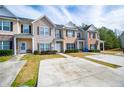 Front exterior view of townhouses showing driveways, landscaping, and design variety at 2326 Bigwood Trl, Atlanta, GA 30349