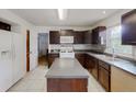 Bright kitchen featuring dark wood cabinetry, a center island, and modern appliances at 4422 Wellington Ter, Decatur, GA 30035