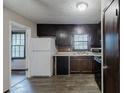 Functional kitchen featuring dark cabinetry, laminate countertops, and standard appliances at 2284 Emerald Springs Dr, Decatur, GA 30035