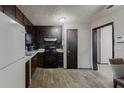 Galley kitchen featuring essential appliances, and sleek, dark wood cabinets at 2284 Emerald Springs Dr, Decatur, GA 30035