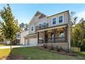 Attractive two-story house showcasing gray siding, brick details, a cozy front porch, and a neatly maintained lawn at 2460 Hidden Creek Rd, Kennesaw, GA 30152