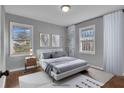 A serene bedroom featuring two windows, hardwood floors, and contemporary decor at 765 Shellnut Dr, Forest Park, GA 30297