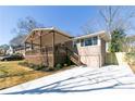 Ranch-style home featuring an inviting covered porch with a wooden railing and ample parking with new driveway at 1826 Terry Mill Se Rd, Atlanta, GA 30316