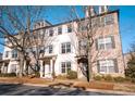 Elegant townhouse with mixed brick and stucco facade, featuring well-maintained landscaping and classic architectural details at 1480 Baygreen Rd, Suwanee, GA 30024