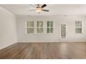 Spacious living room with hardwood floors, lots of natural light, and a ceiling fan for added comfort at 1094 Georgian Point Rd, Lawrenceville, GA 30045