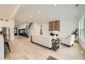 Open-concept living room with hardwood floors, a fireplace, staircase, and lots of natural light at 1523 Grayson Pkwy, Grayson, GA 30017