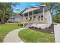 Charming home with a covered porch, well-maintained lawn and inviting walkway at 3279 Elm St, College Park, GA 30337