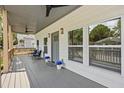 Inviting covered porch with outdoor seating, ceiling fans, and a view of the neighborhood at 3279 Elm St, College Park, GA 30337