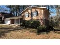 A charming house with a well-manicured lawn and complemented by the natural beauty of surrounding trees at 4100 Seneca Way, Stone Mountain, GA 30083