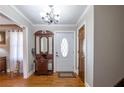 Inviting foyer with hardwood floors, a decorative mirror, and neutral wall paint at 2421 Pittman Cir, Cumming, GA 30040