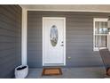 A close-up of the white front door with an oval glass insert, framed by the home's siding at 2421 Pittman Cir, Cumming, GA 30040