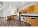 Modern kitchen featuring stainless steel appliances, wood cabinets and dark countertops at 5300 Peachtree Rd # 3507, Chamblee, GA 30341