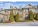 Charming brick townhome featuring manicured landscaping and classic architectural details at 7420 Glisten Ave, Sandy Springs, GA 30328