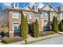 Beautiful brick townhome with mature landscaping, inviting curb appeal, and a welcoming entrance at 7420 Glisten Ave, Sandy Springs, GA 30328